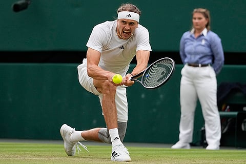 Alexander Zverev plays a backhand return to Taylor Fritz